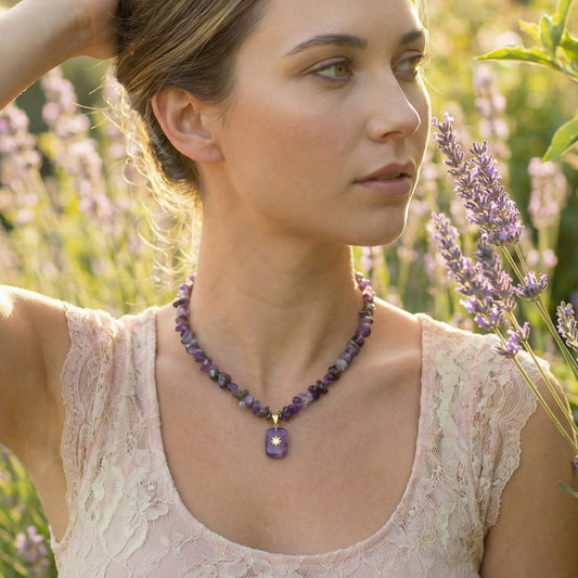 Woman wearing a necklace with a purple pendant in a lavender field