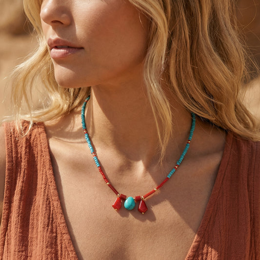 Close-up of a woman wearing a necklace with red and blue beads.