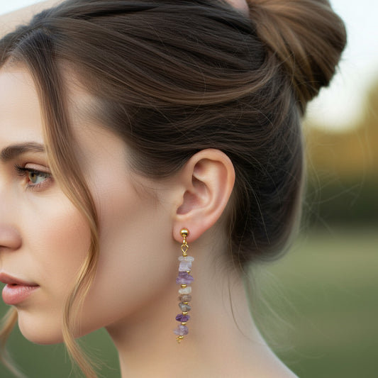 Close-up of a woman wearing colorful beaded earrings with a blurred natural background
