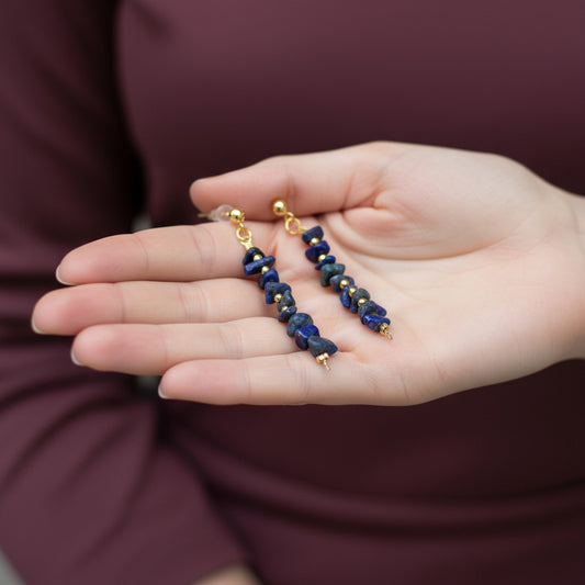Person holding a pair of Lapis Lazuli Crystal Stone Earrings in their hand.