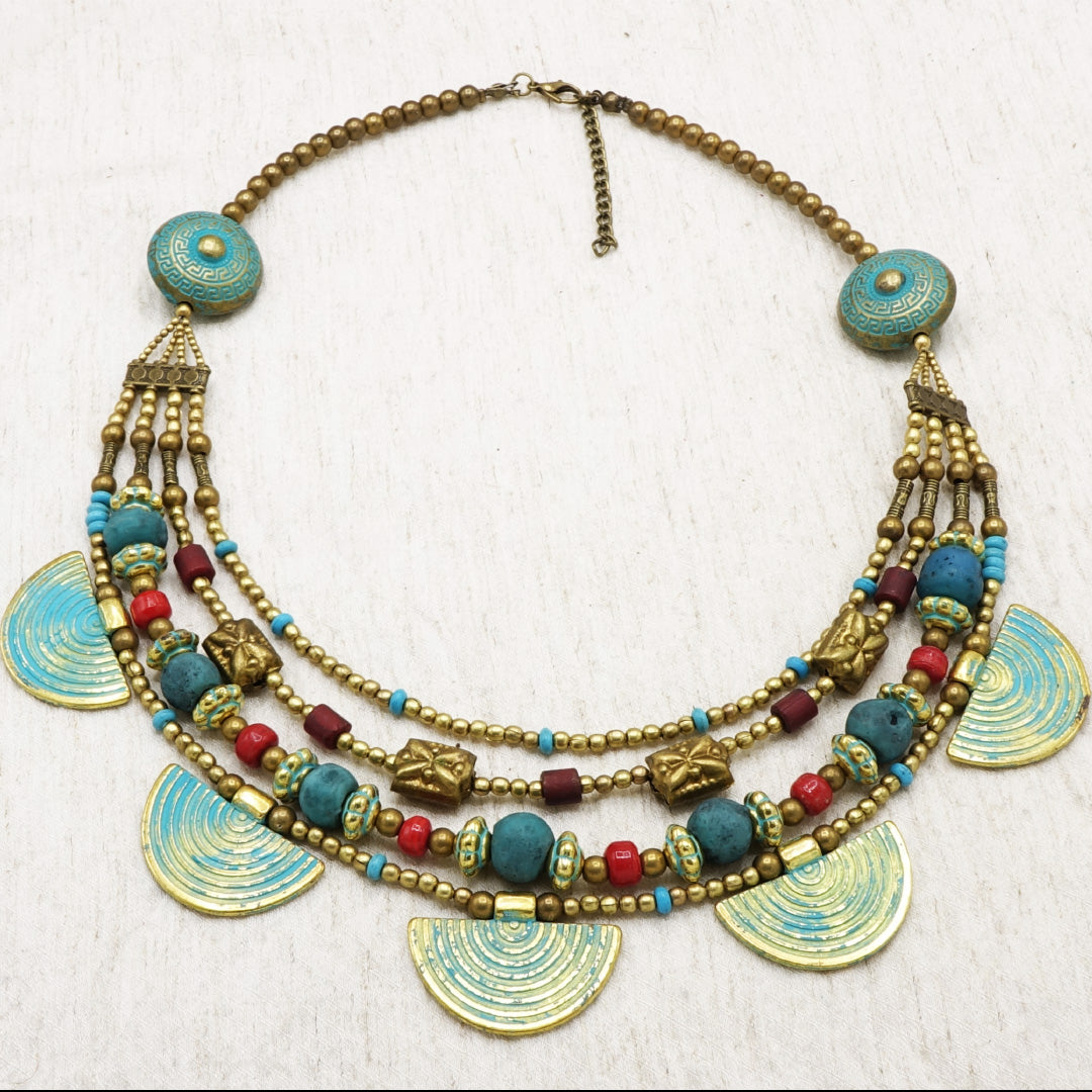Colorful beaded necklace with decorative elements on a white background