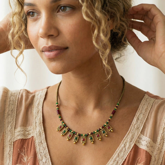 Woman wearing a decorative necklace with a neutral background
