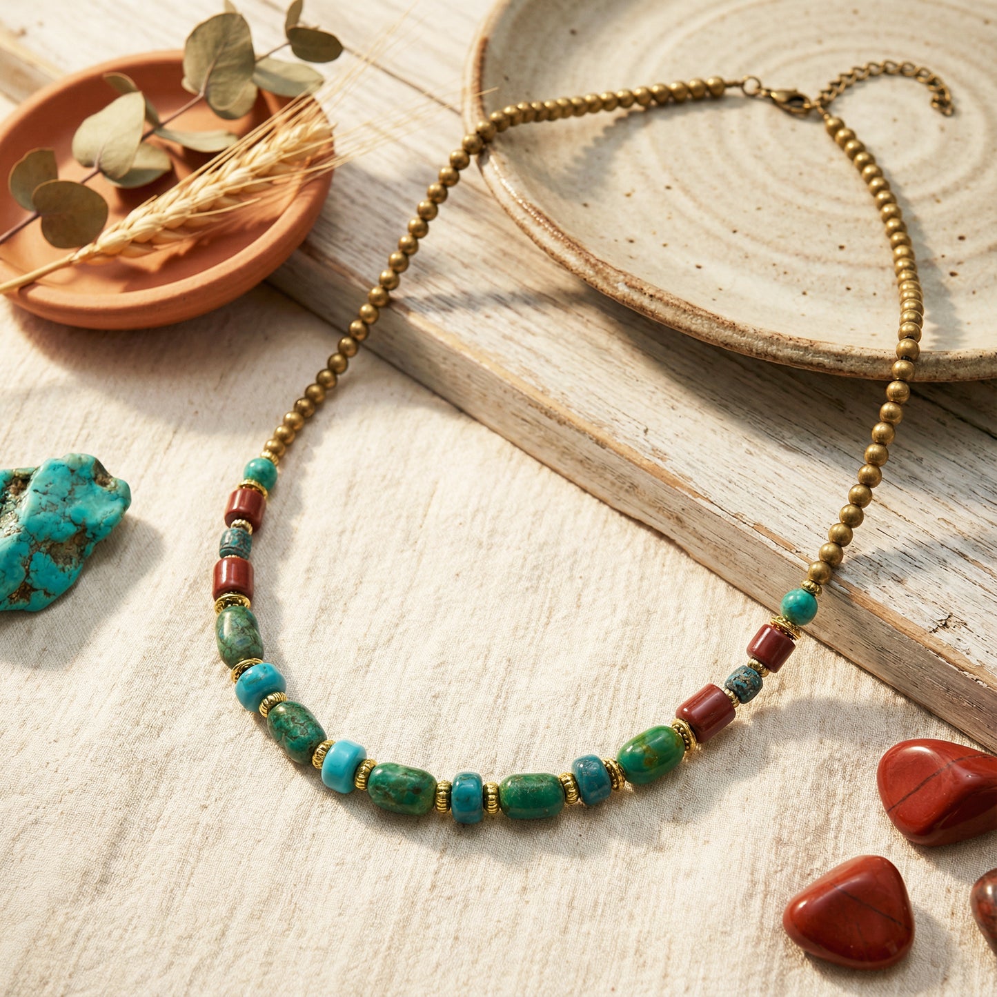 Necklace with green and red beads on a wooden surface with natural elements