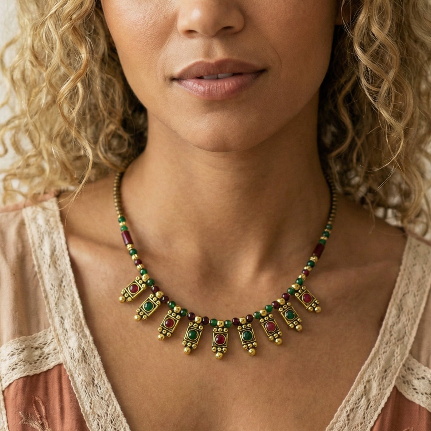 Woman wearing a colorful beaded necklace with a neutral background