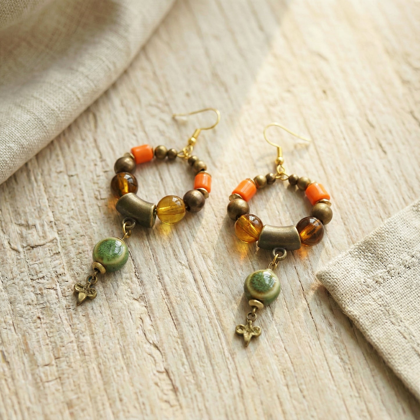 Pair of beaded earrings on a wooden surface