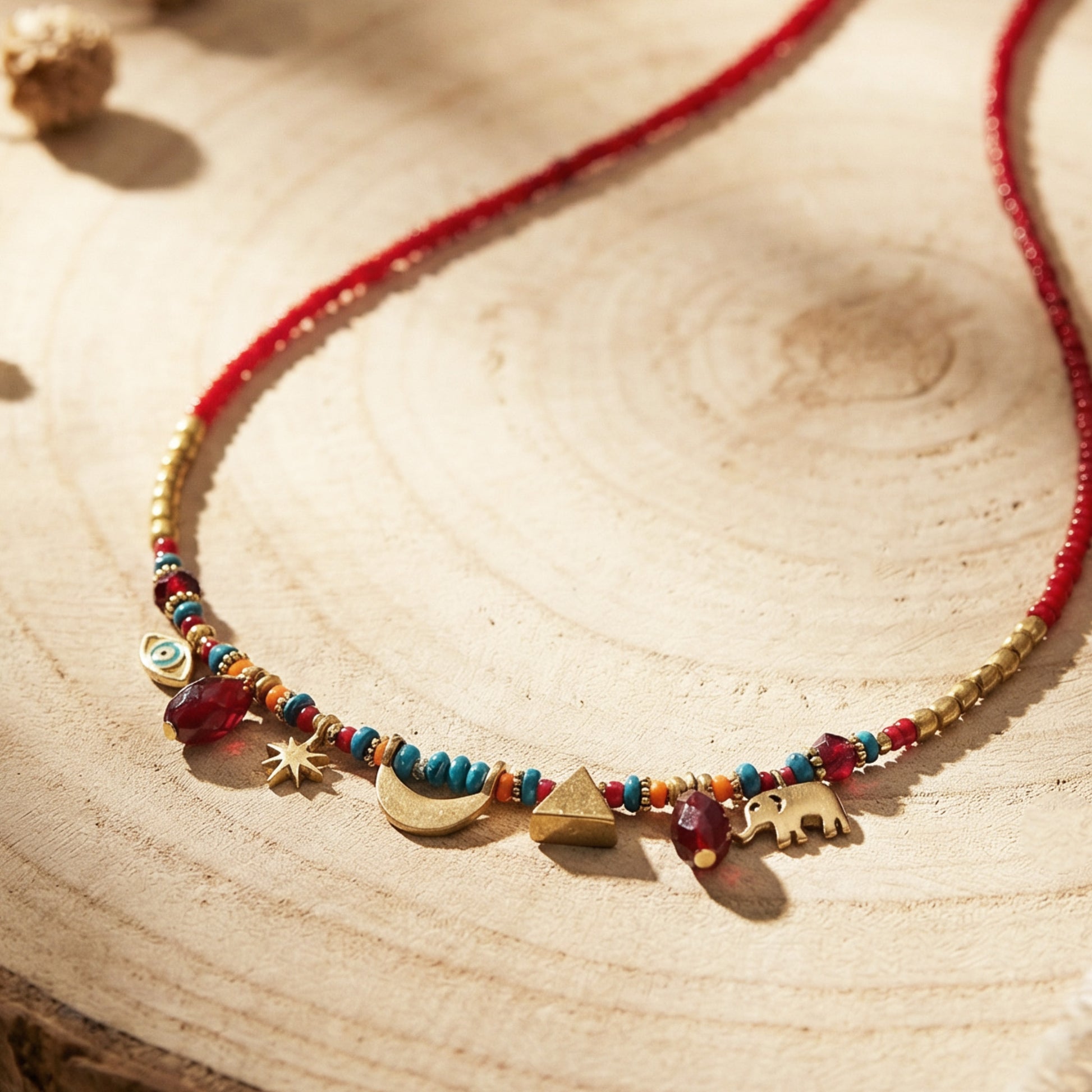Necklace with colorful beads and charms on a wooden surface