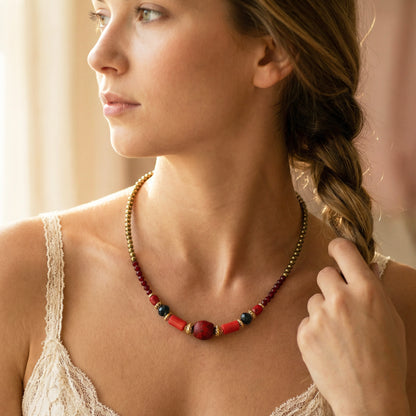 Woman wearing a colorful beaded necklace with a blurred background