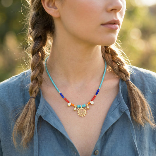 Woman wearing a colorful beaded necklace with braided hair outdoors