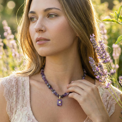 Woman wearing a necklace with a purple pendant in a lavender field