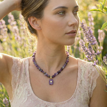 Woman wearing a necklace with a purple pendant in a lavender field