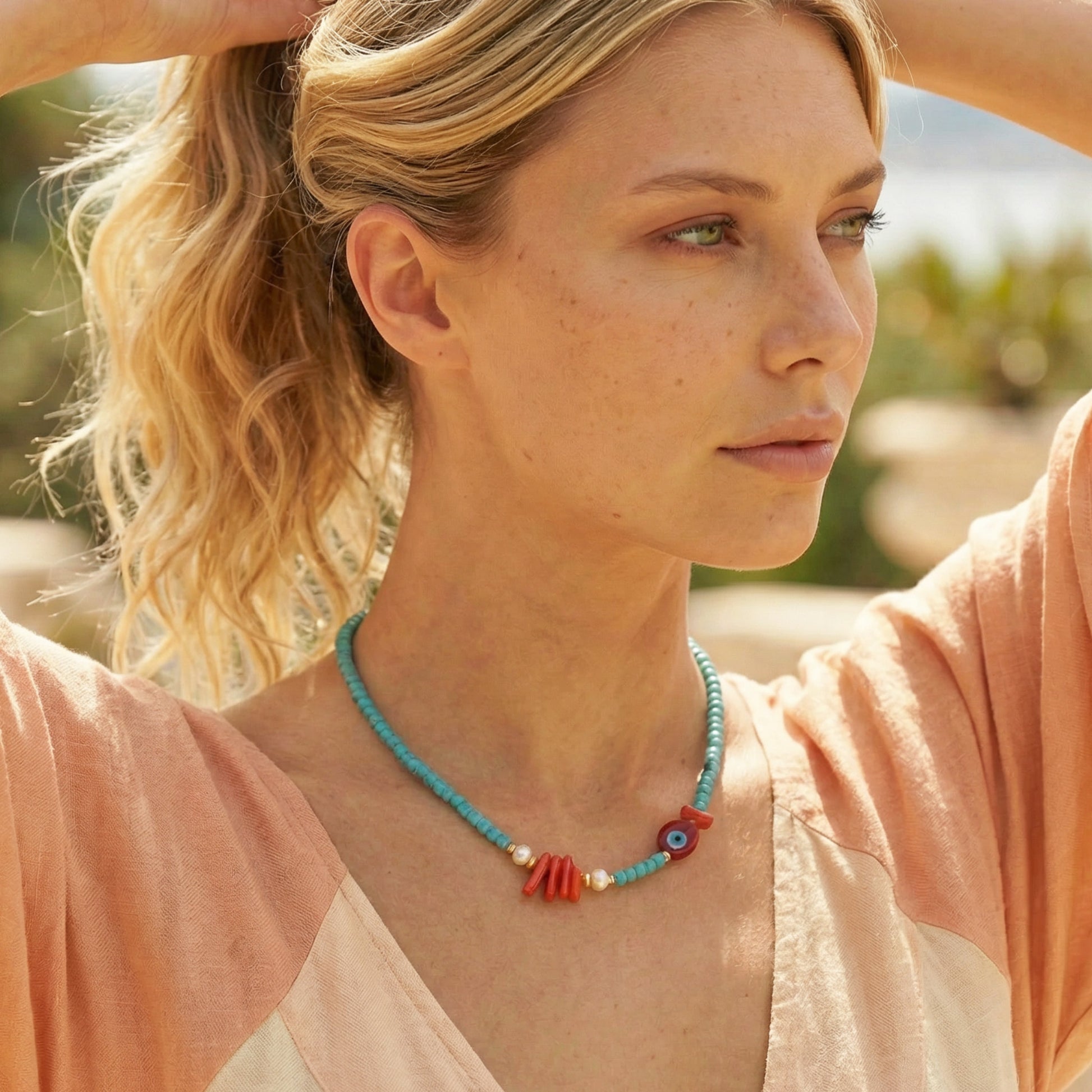 Woman wearing a colorful necklace outdoors with a blurred natural background