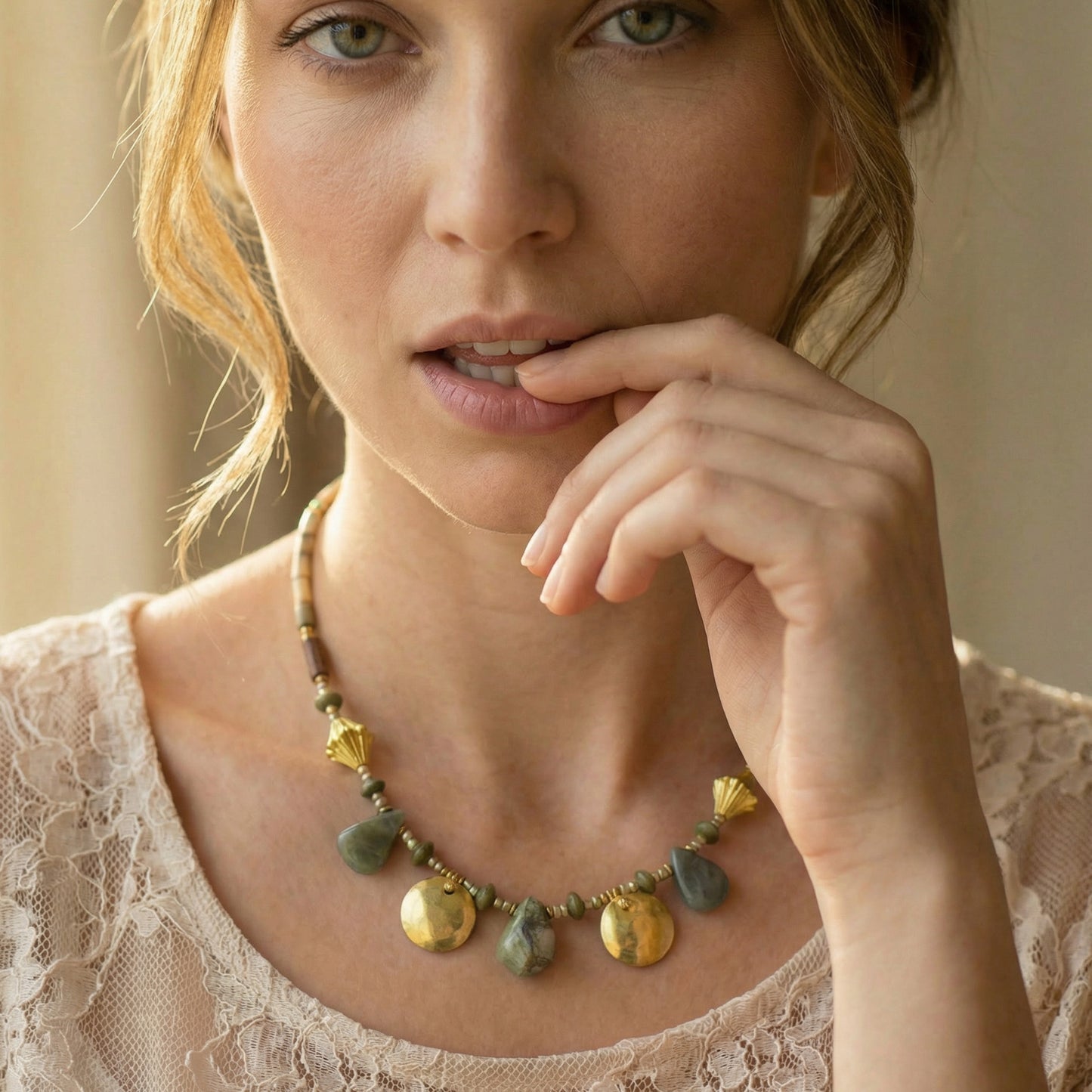 Woman wearing a necklace with a neutral background