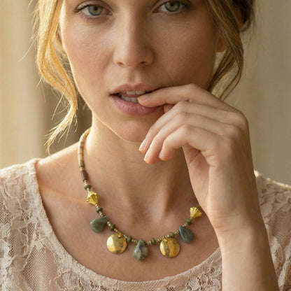 Woman wearing a necklace with a neutral background