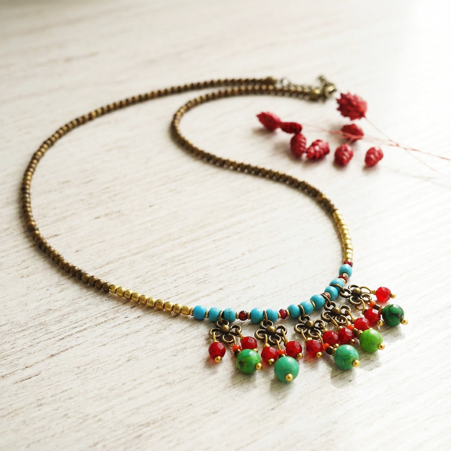 Necklace with colorful beads on a light wooden surface
