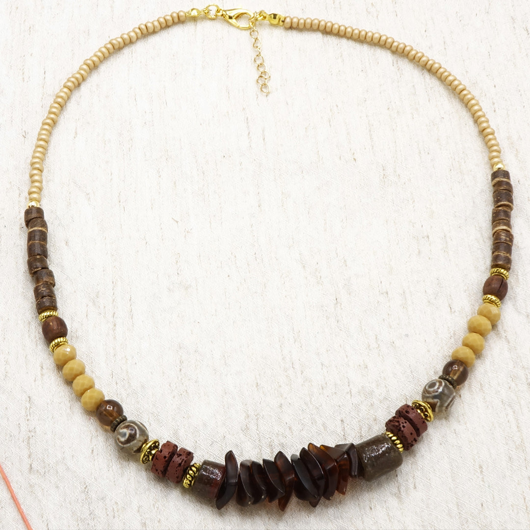 Necklace with brown and beige beads on a white background