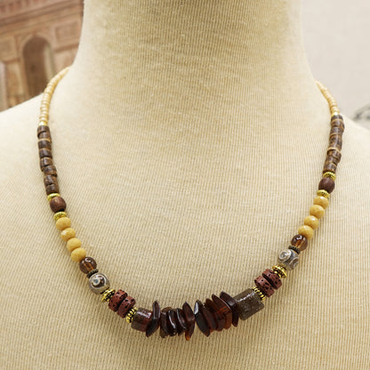 Beaded necklace on a mannequin with a blurred background