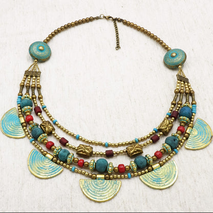 Colorful beaded necklace with decorative elements on a white background