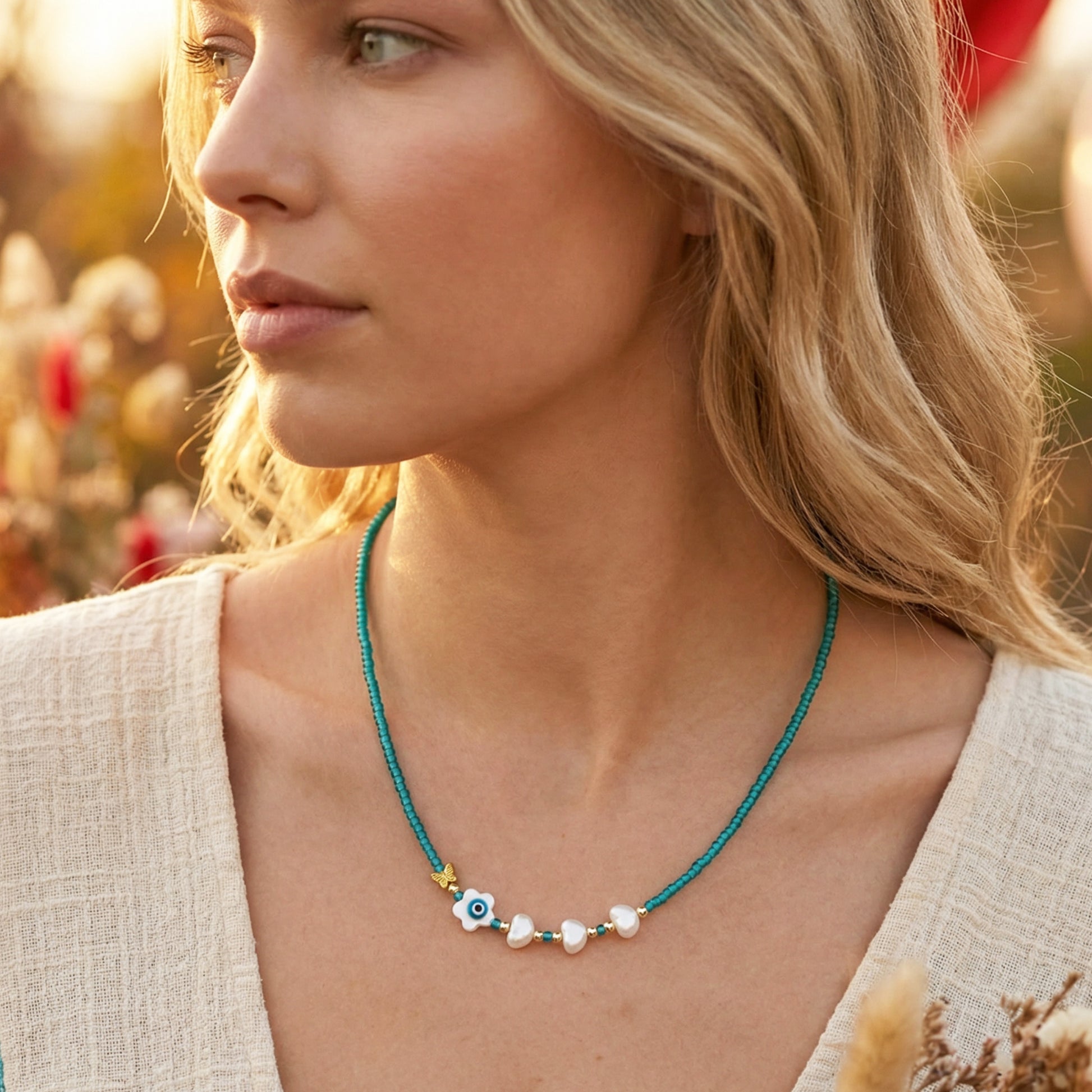 Woman wearing a blue necklace with small beads outdoors