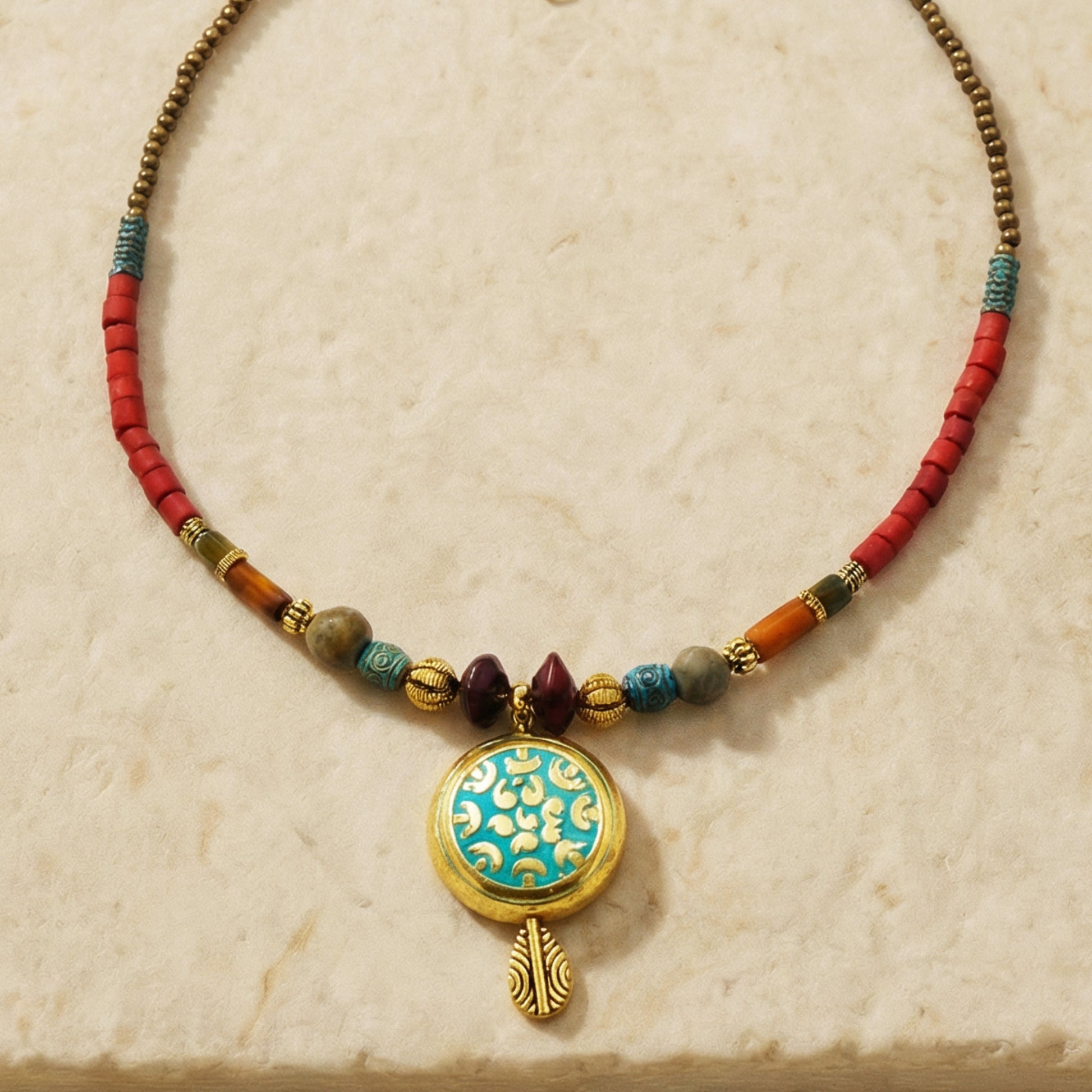 Necklace with colorful beads and a decorative pendant on a beige background