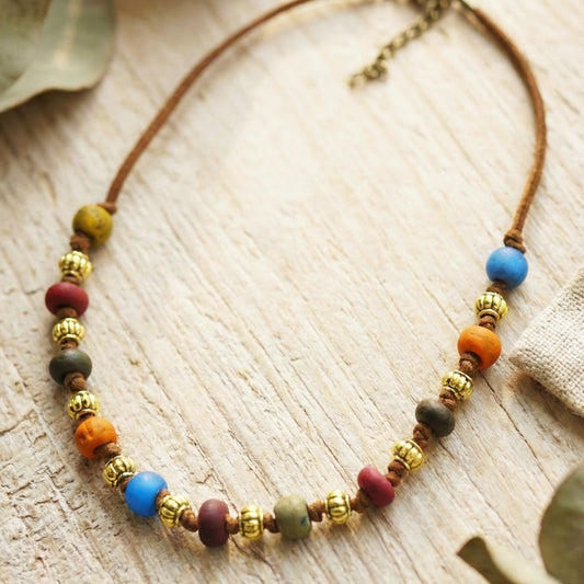 Necklace with colorful beads on a wooden surface