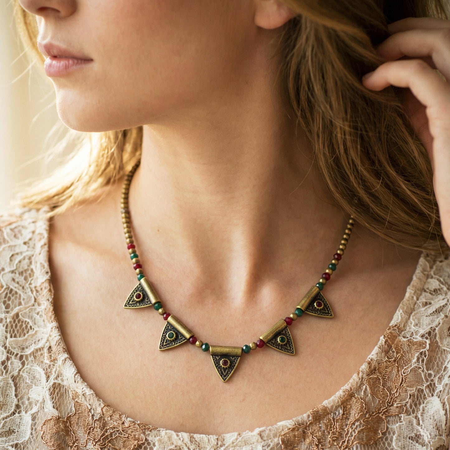 Close-up of a woman wearing a decorative necklace with geometric designs.