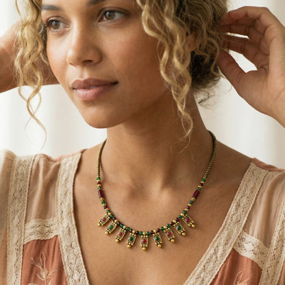 Woman wearing a decorative necklace with a neutral background