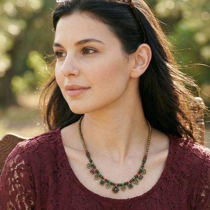 Woman wearing a necklace with a blurred natural background