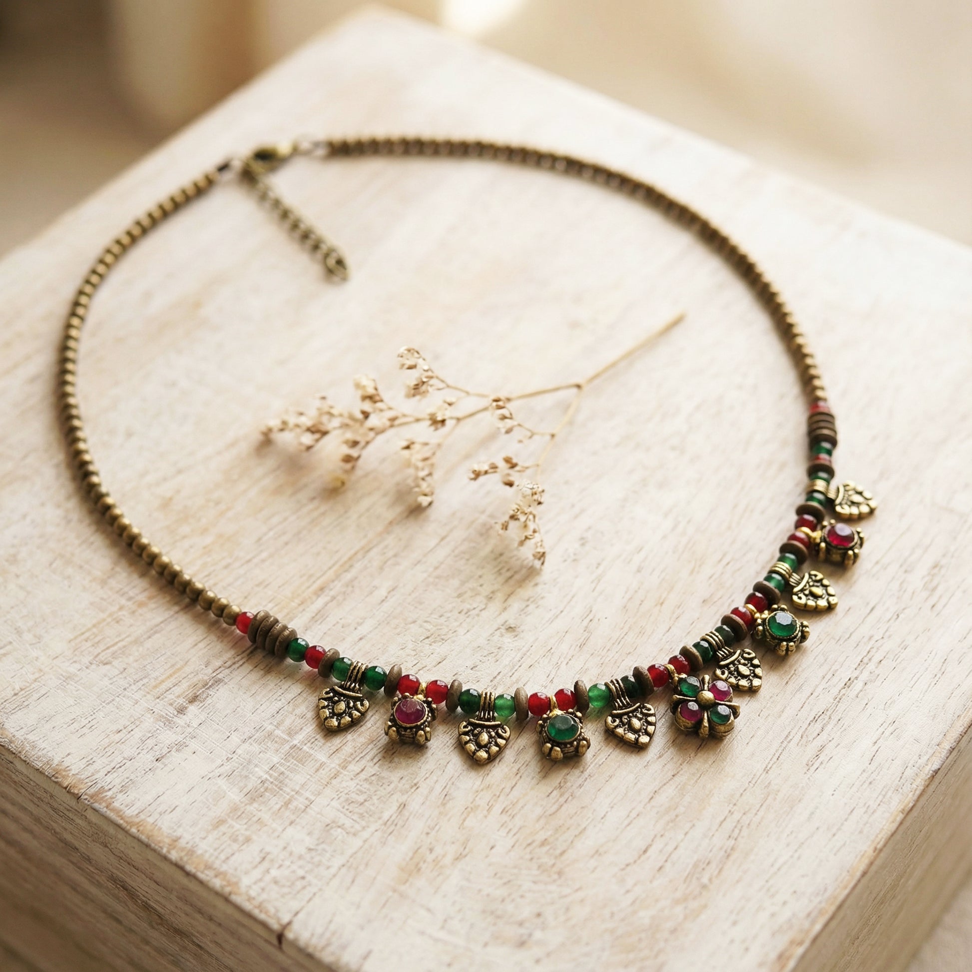 Necklace with colorful beads and decorative elements on a wooden surface