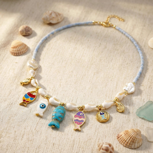 Necklace with fish charms on a sandy background