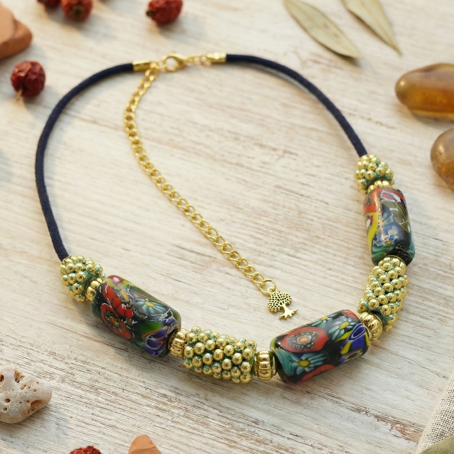 Necklace with colorful beads and gold chain on a wooden surface