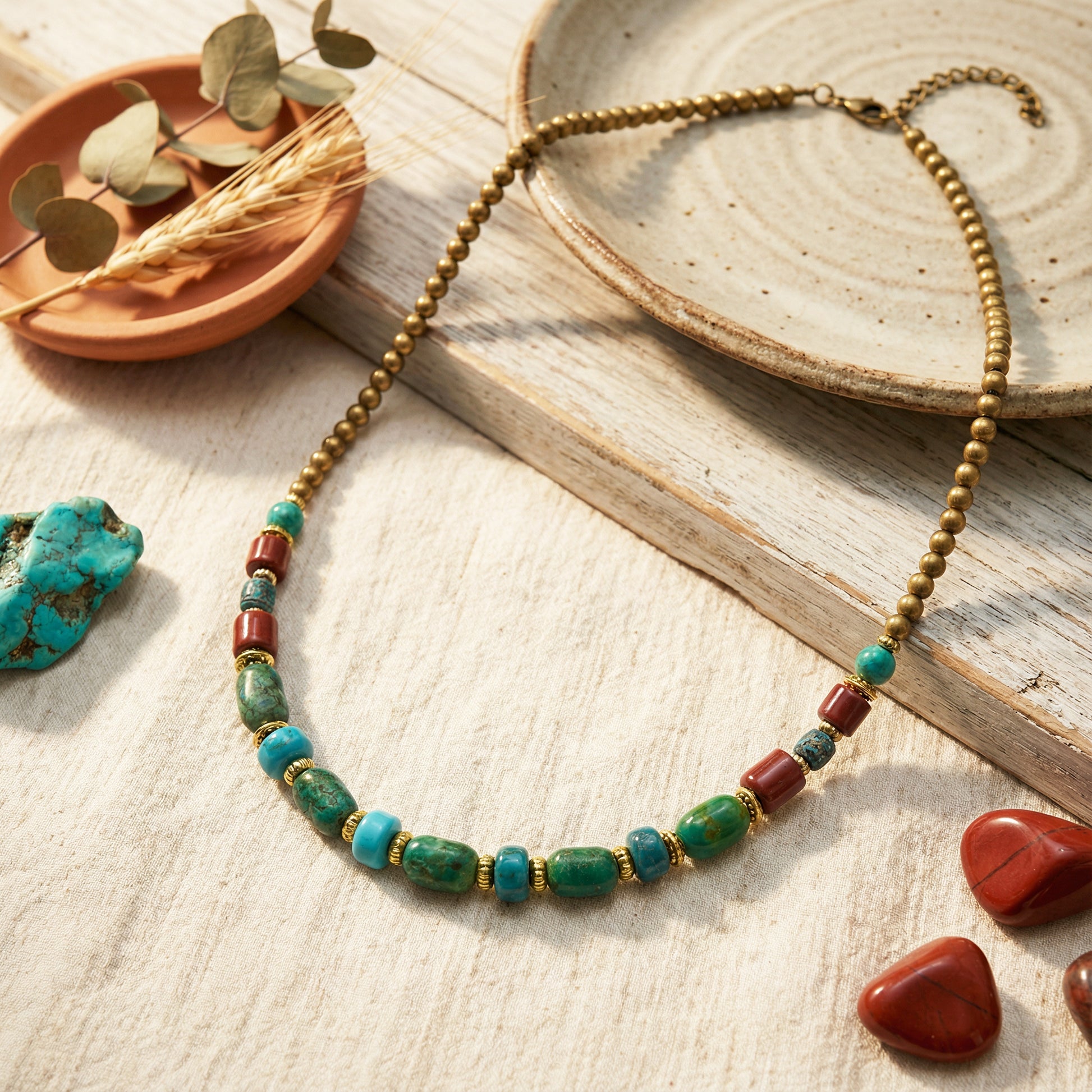 Necklace with green and red beads on a wooden surface with natural elements