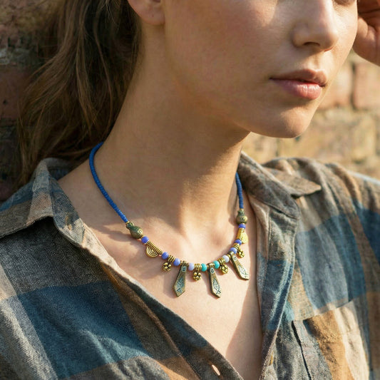 Close-up of a person wearing a colorful necklace outdoors