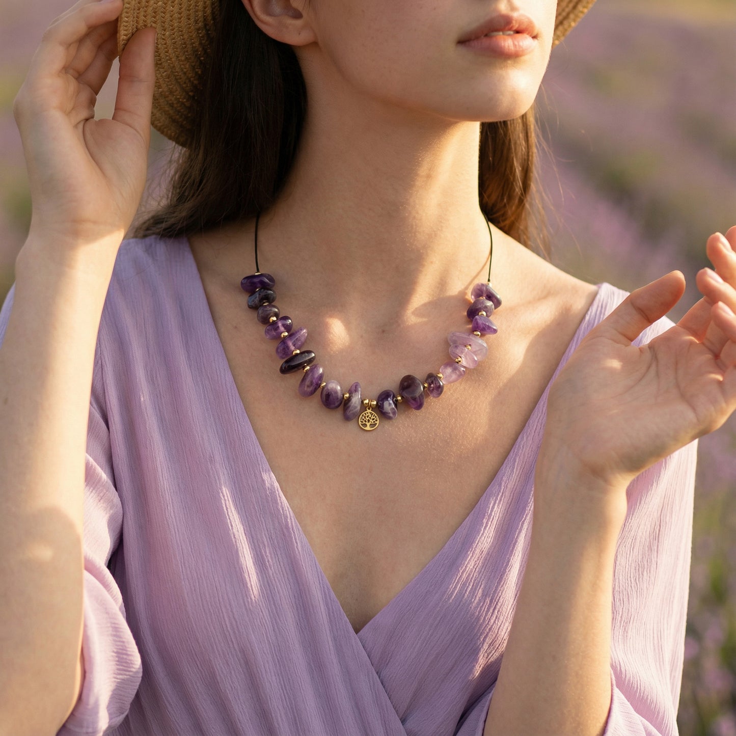 Woman wearing a purple dress and necklace with a blurred lavender field background