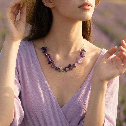 Woman wearing a purple dress and necklace with a blurred lavender field background