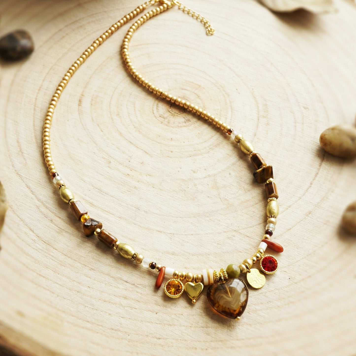 Necklace with multicolored beads and stones on a wooden surface