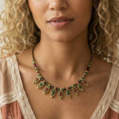 Woman wearing a colorful beaded necklace with a neutral background