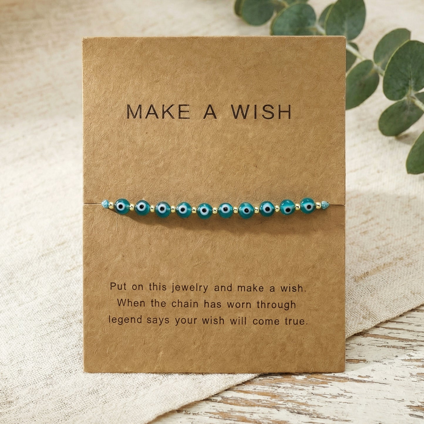 Bracelet with blue beads on a 'Make a Wish' card with text.