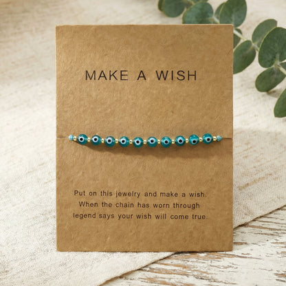 Bracelet with blue beads on a 'Make a Wish' card with text.