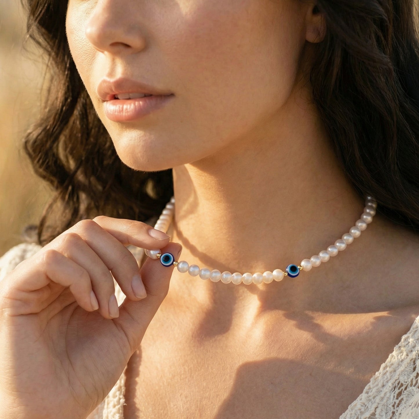 Close-up of a woman wearing a pearl necklace with a blurred background