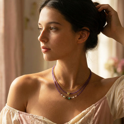 Woman wearing a necklace with a soft, blurred background