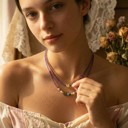 Woman wearing a necklace with a soft, warm background