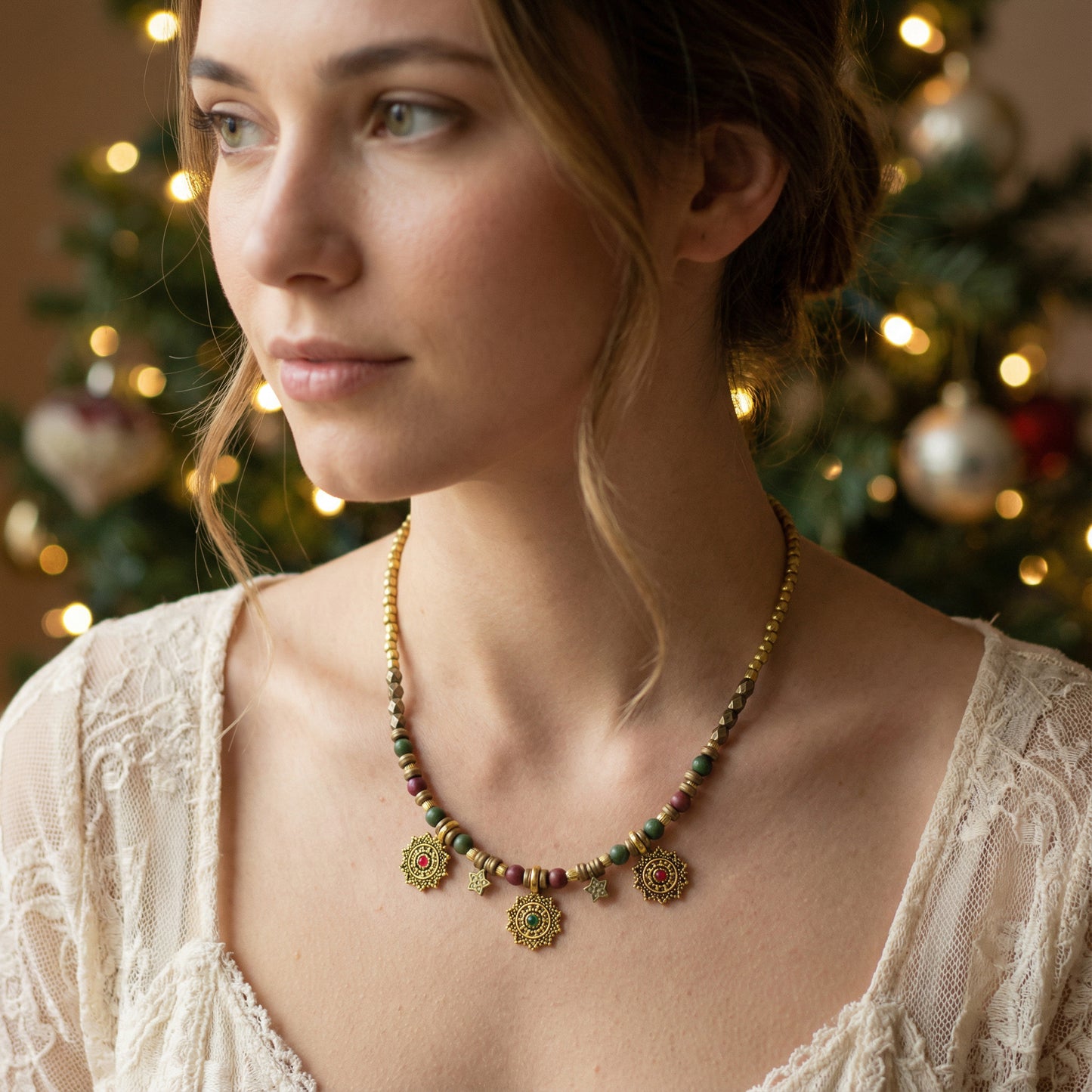 Woman wearing a beaded necklace with Christmas trees in the background