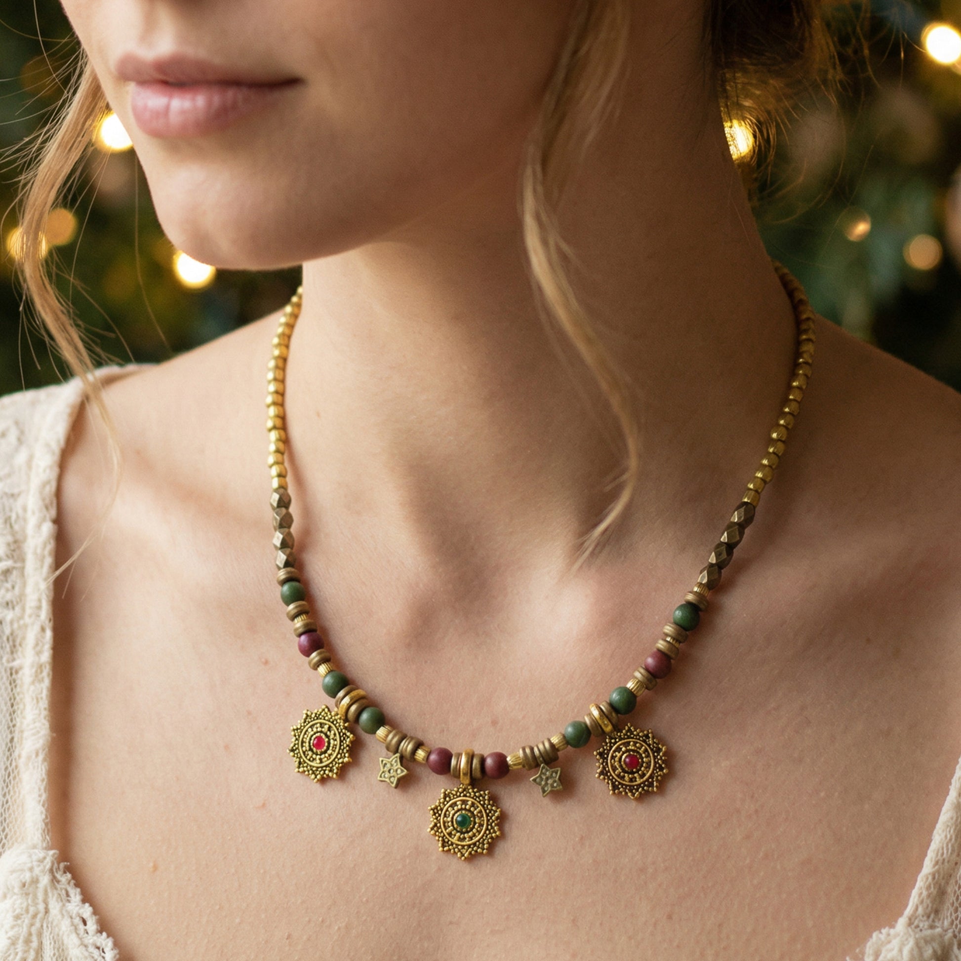 Close-up of a person wearing a decorative necklace with beads and gold pendants.